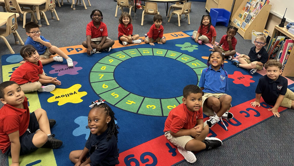 large group of children sitting on a circle