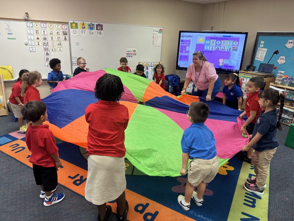 group of children playing with a parachute